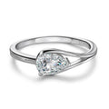 Bee-Bees 1ct pear cut moissanite engagement ring in sterling silver with 18k white gold plating. Features a D-color, VVS1 clarity stone.