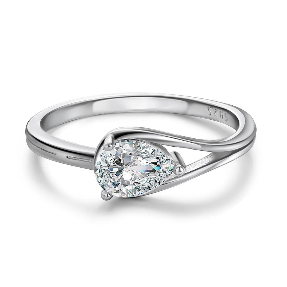 Bee-Bees 1ct pear cut moissanite engagement ring in sterling silver with 18k white gold plating. Features a D-color, VVS1 clarity stone.