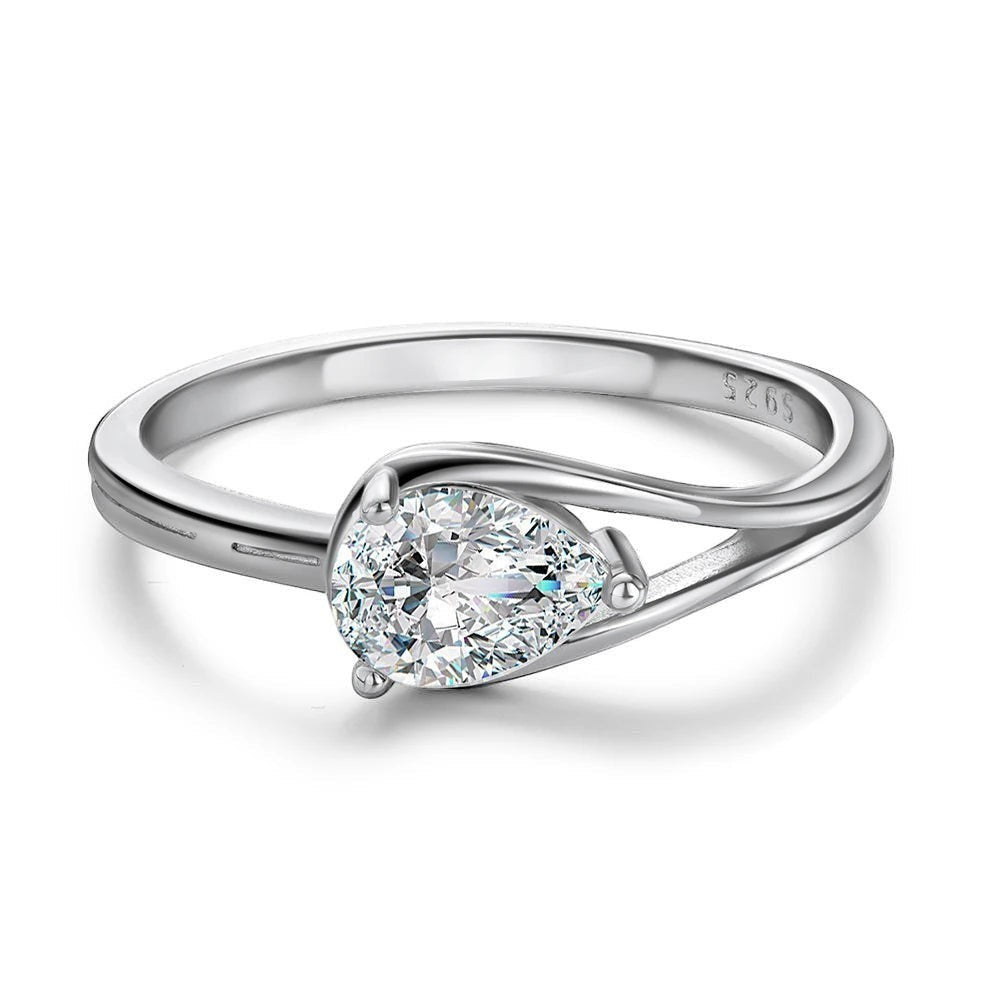 Bee-Bees 1ct pear cut moissanite engagement ring in sterling silver with 18k white gold plating. Features a D-color, VVS1 clarity stone.