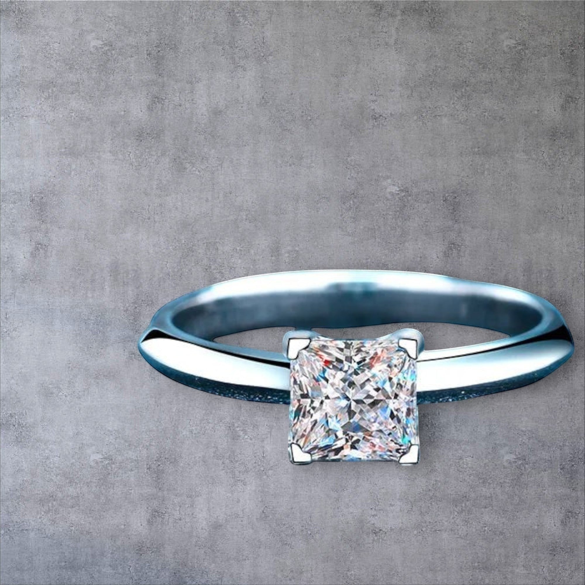 Bee-Bees Princess cut moissanite engagement ring in sterling silver with 18K white gold plating.