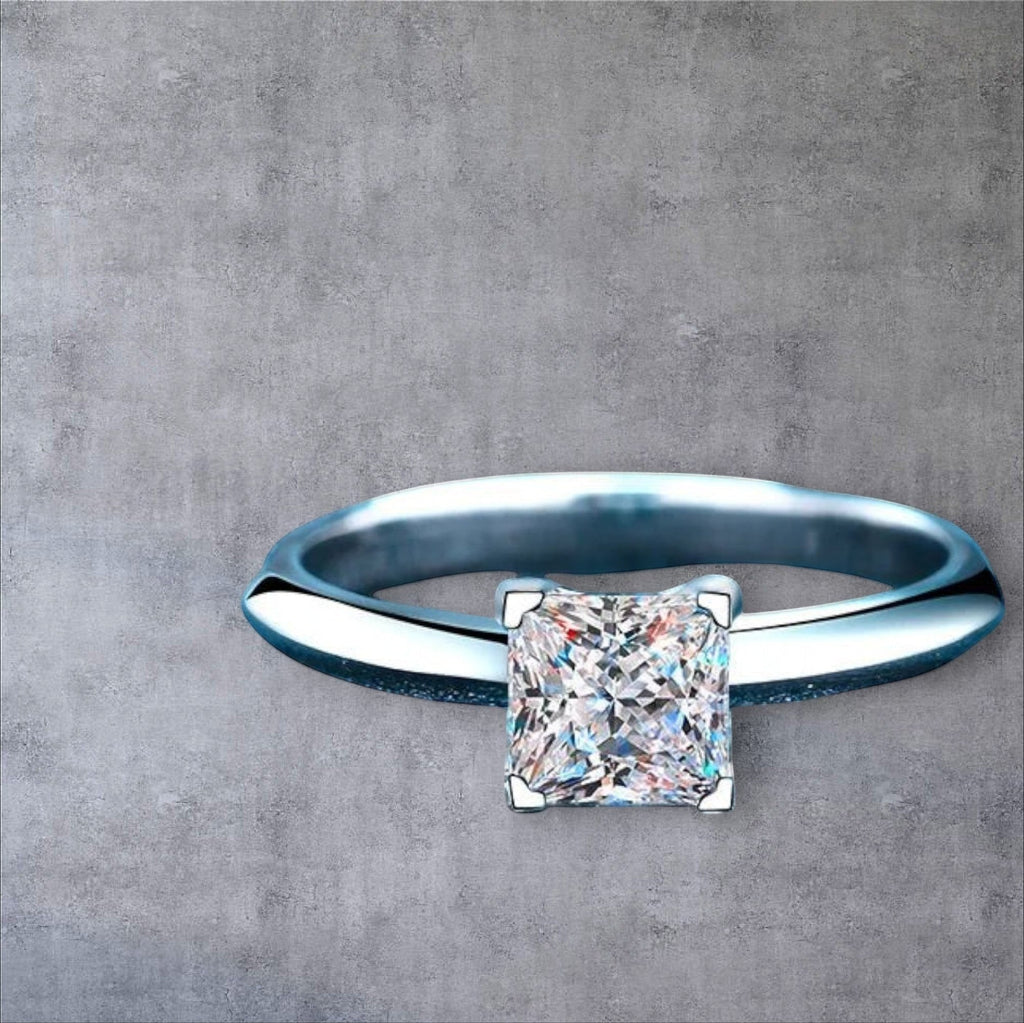 Bee-Bees Princess cut moissanite engagement ring in sterling silver with 18K white gold plating.