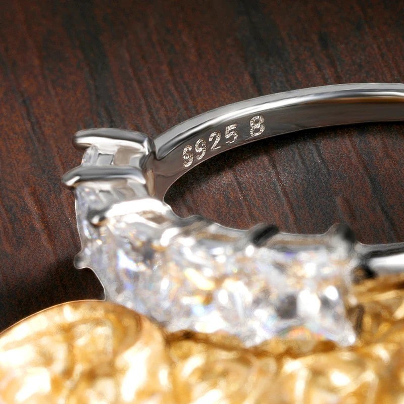 Bee-Bees 18k gold-plated sterling silver wedding band with princess-cut moissanite stones.
