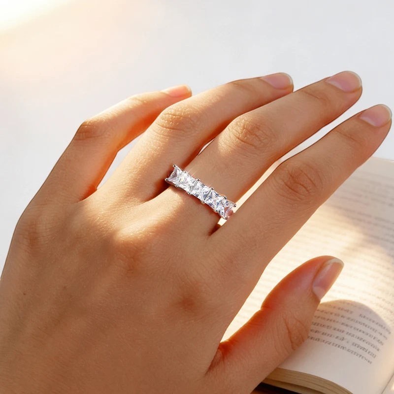 Bee-Bees Princess cut moissanite wedding band in 18k gold-plated sterling silver with five square stones.