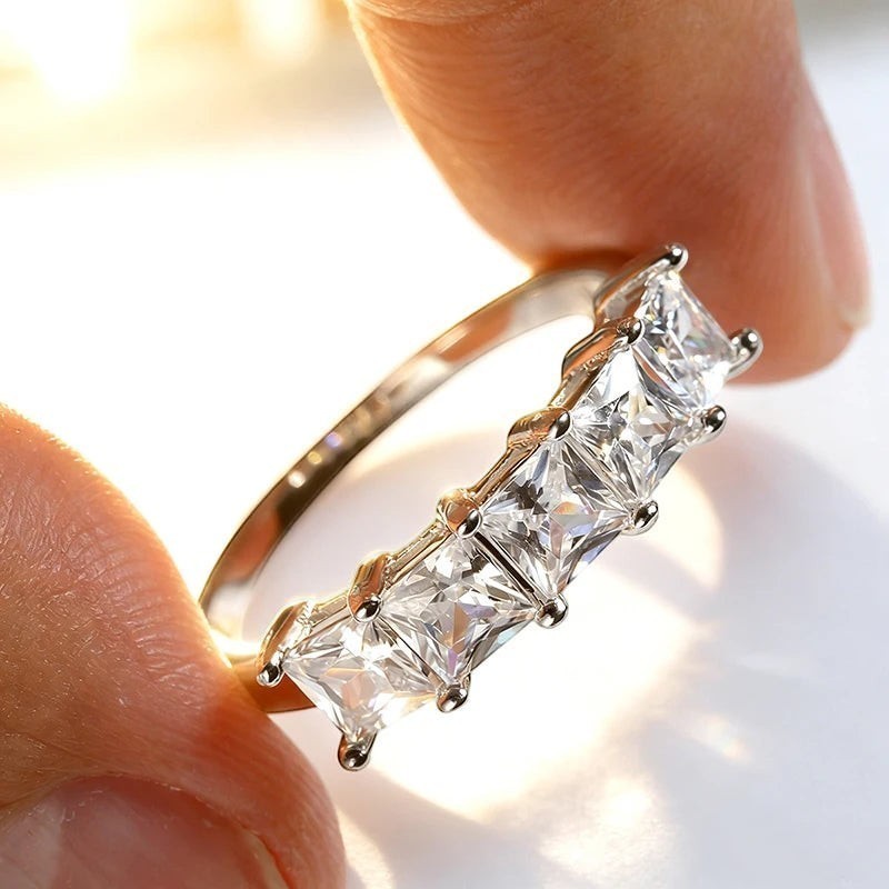 Bee-Bees Princess cut moissanite wedding band in 18k gold-plated sterling silver with five square stones.