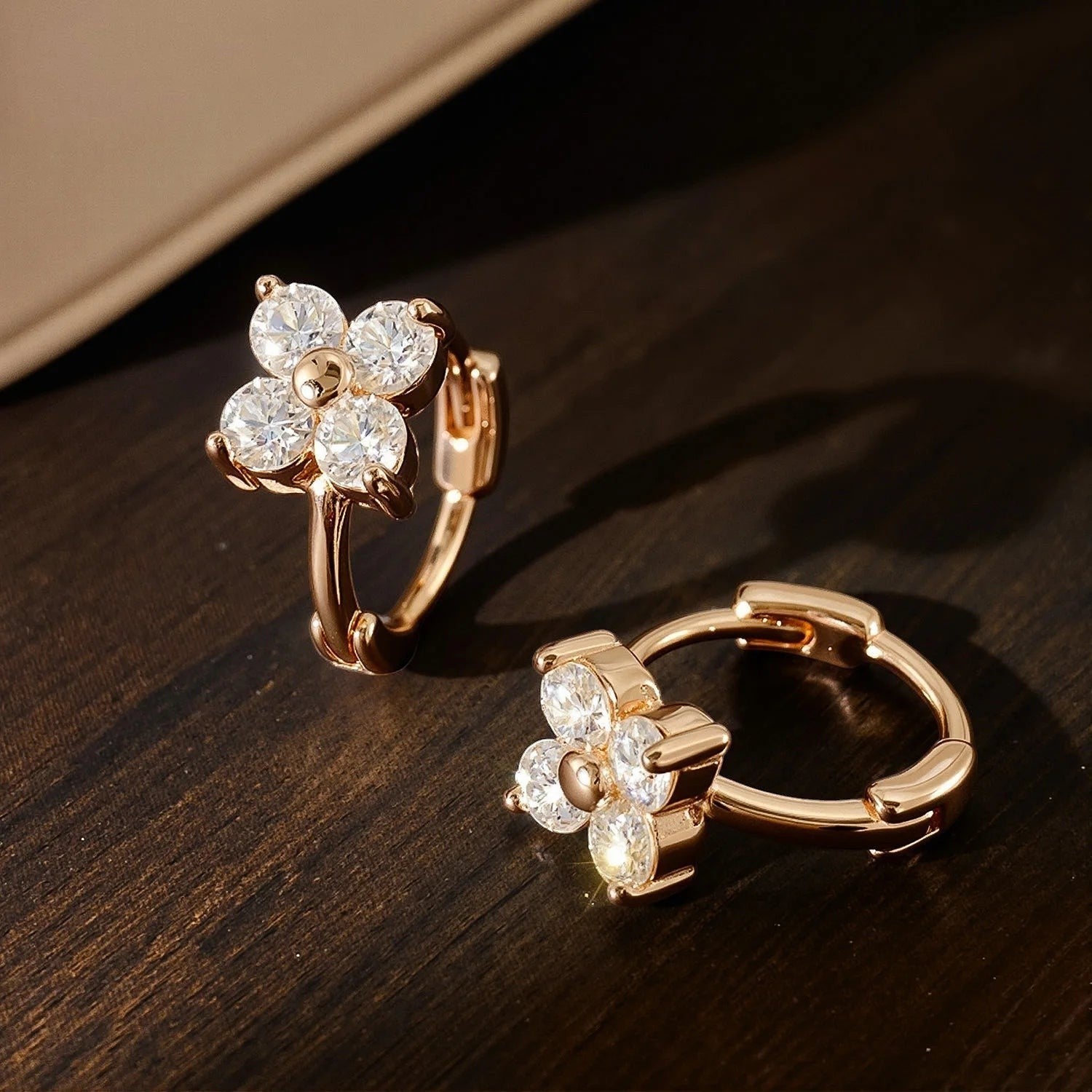 Bee-Bee's rose gold sterling silver hoop earrings with 3mm moissanite stones in a flower design.