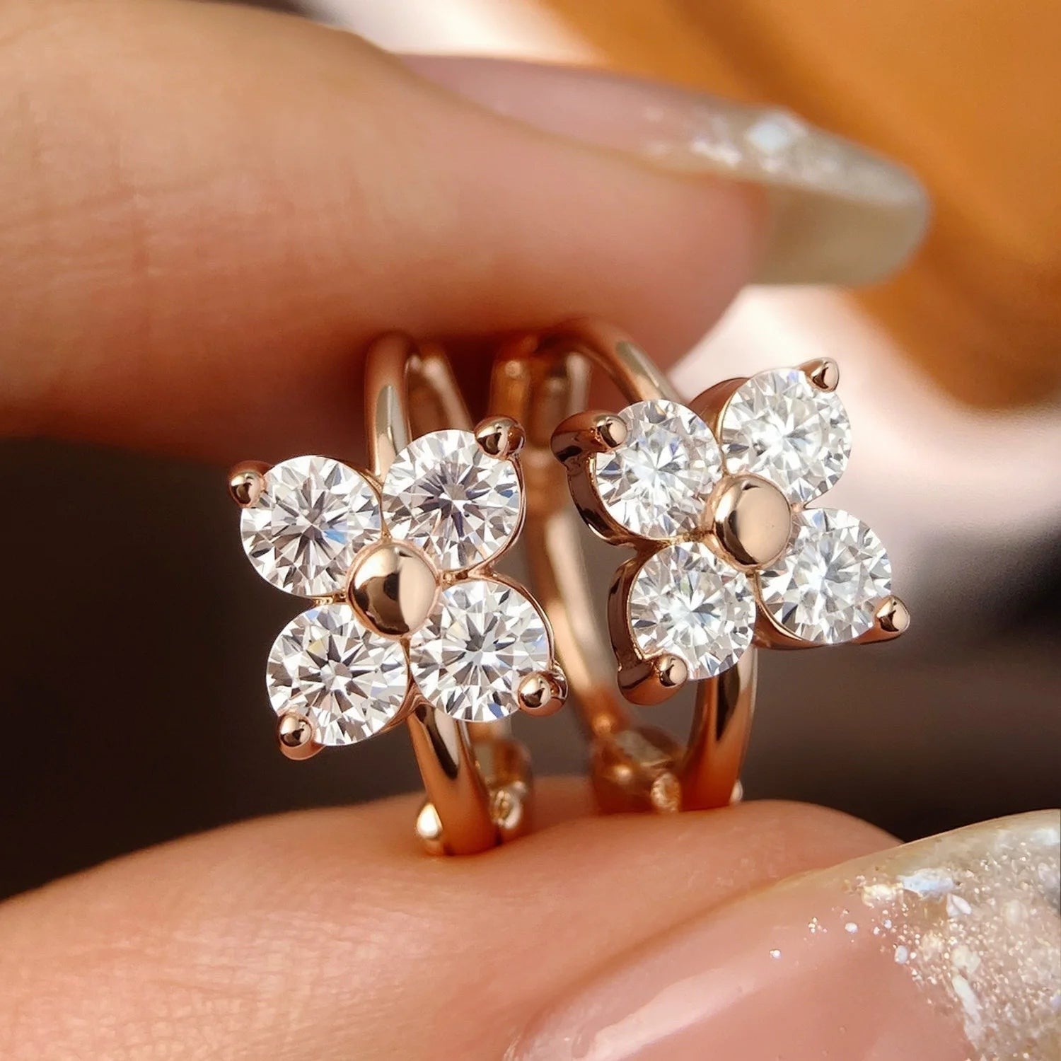 Bee-Bee's rose gold 925 sterling silver hoop earrings with 3mm D Color VVS1 moissanite stones in a floral cluster design.