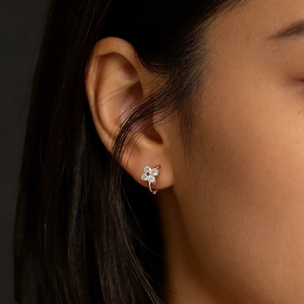 Bee-Bee's rose gold 925 sterling silver hoop earrings with 3mm D color VVS1 moissanite stones in a floral design.