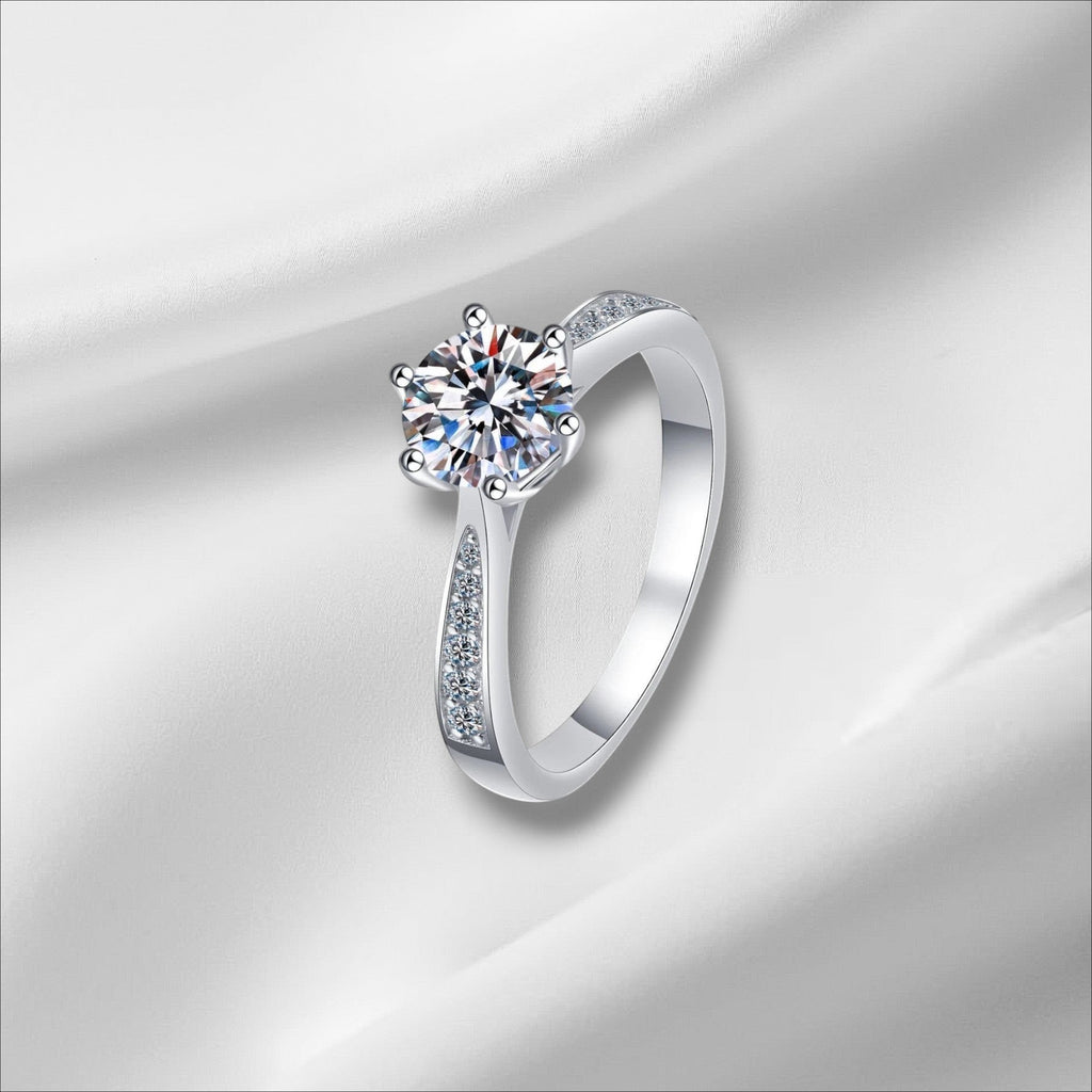 Bee-Bee's sterling silver engagement ring with a round D VVS1 moissanite center stone and pavé accents on the band.