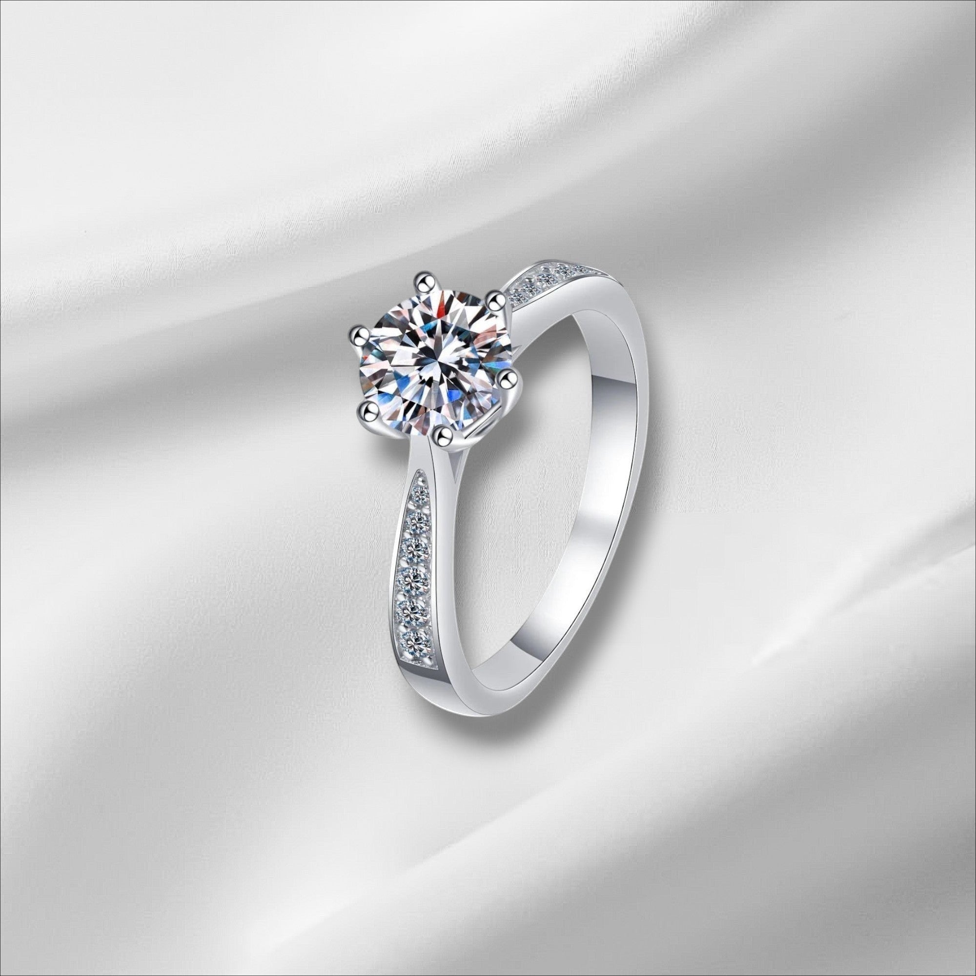 Bee-Bee's sterling silver engagement ring with a round D VVS1 moissanite center stone and pavé accents on the band.