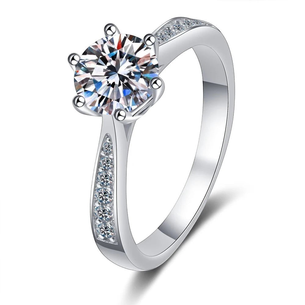 Bee-Bee's sterling silver engagement ring with a round D VVS1 moissanite center stone and pavé accents on the band.