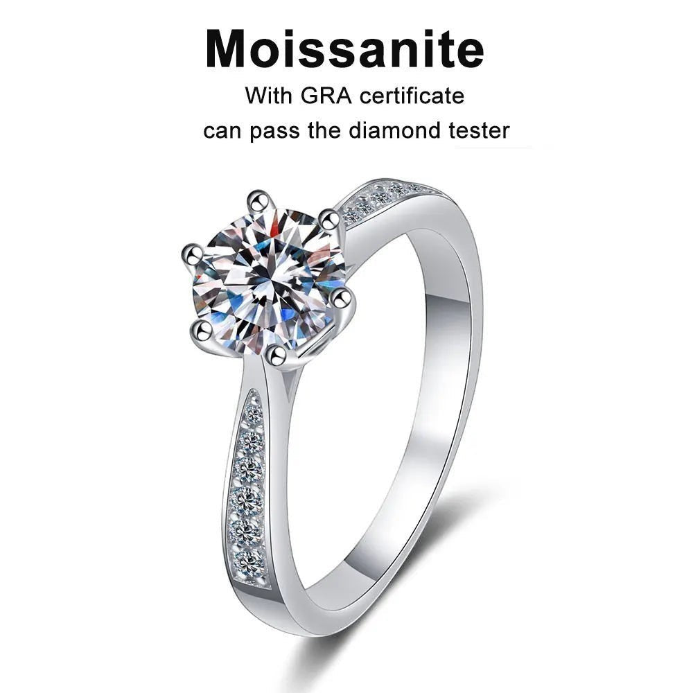 Bee-Bee's classic round moissanite solitaire engagement ring in sterling silver with accent stones on the band.