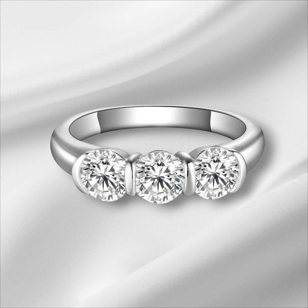 Bee-Bees 5mm round moissanite engagement ring in 925 sterling silver with 18k white gold plating. Features three brilliant-cut stones.