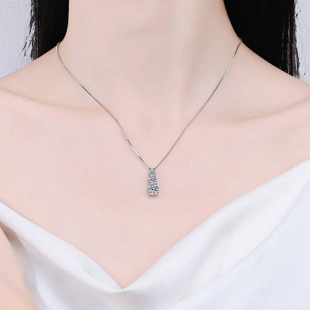 Bee-Bees sterling silver necklace with a vertical pendant of three round brilliant cut moissanite stones, D color, VVS1 clarity.