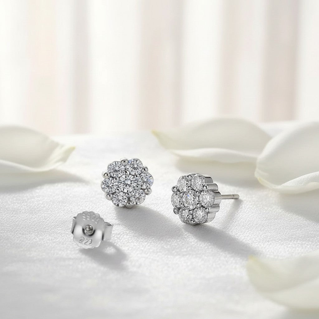 Bee-Bees round moissanite stud earrings in white gold plated sterling silver, featuring a floral cluster design with multiple small stones.