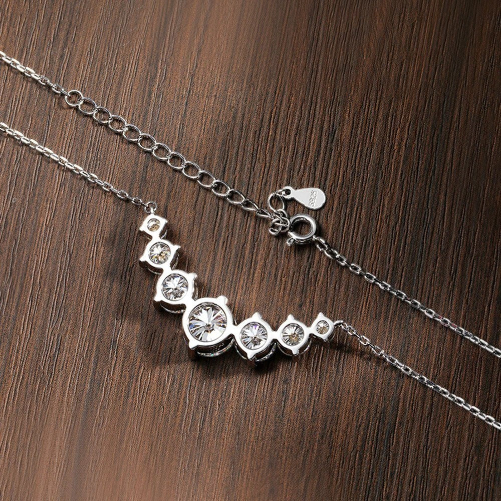 Bee-Bee's sterling silver necklace with a curved line of sparkling round-cut moissanite stones, 18K white gold plated.