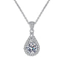 Bee-Bees teardrop pendant necklace with a D color VVS1 moissanite center stone surrounded by small zircons, set in 925 sterling silver with white gold plating.