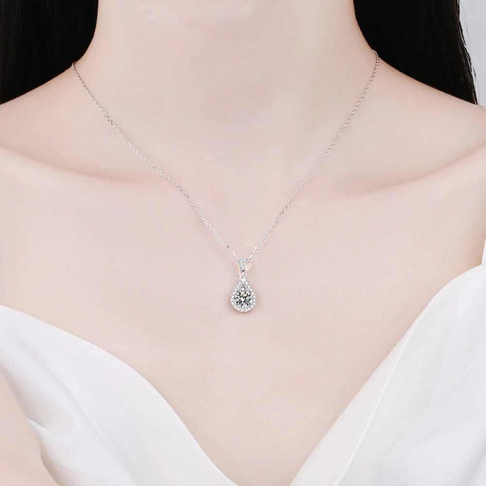 Bee-Bees teardrop pendant necklace with a D Color VVS1 moissanite stone in 925 sterling silver with a halo of smaller stones.