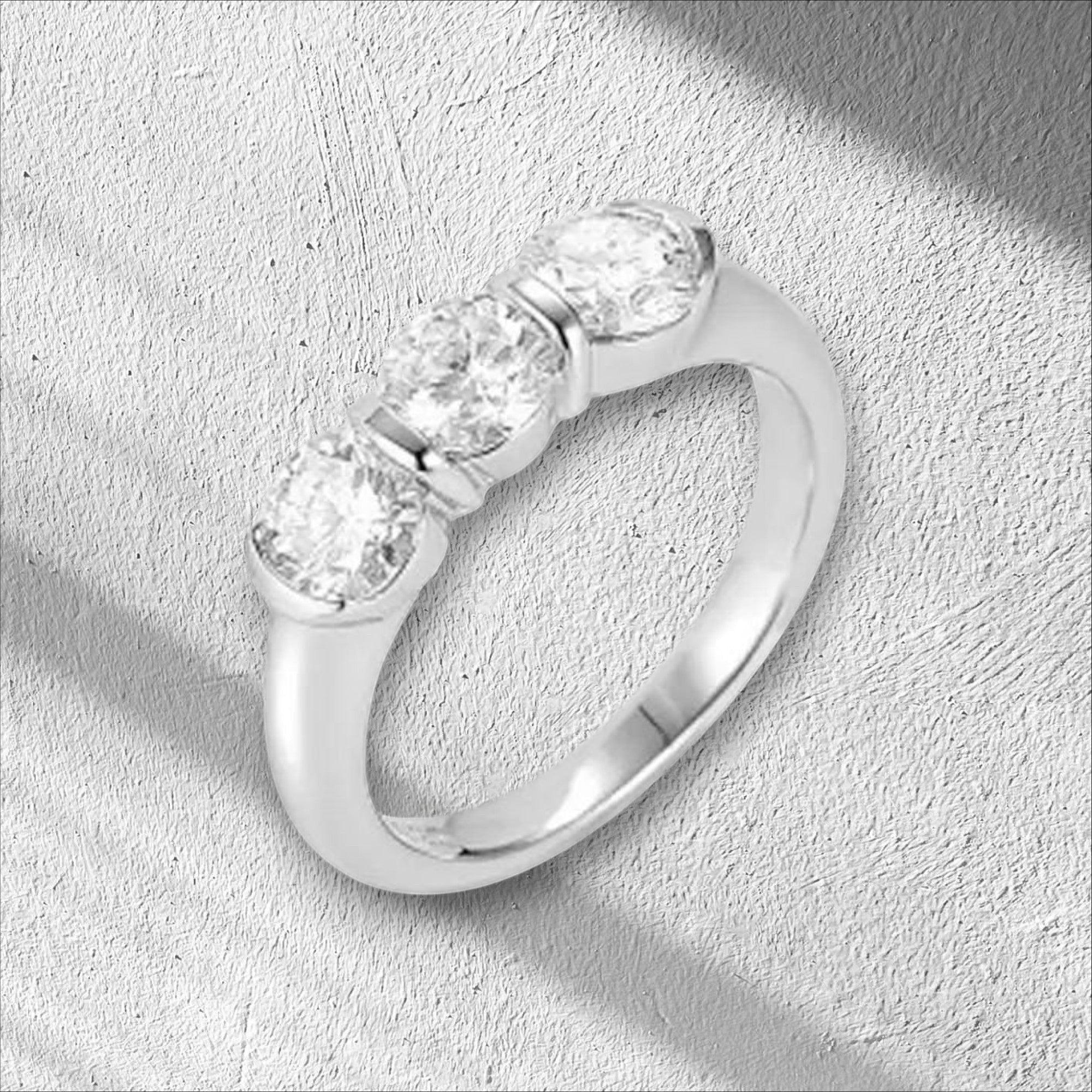 Bee-Bees three round moissanite stones set in a silver band, 5mm each, GRA certified.