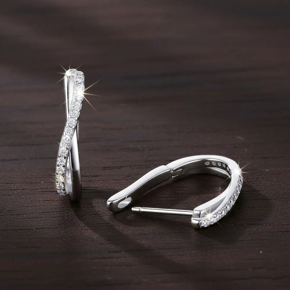 Bee-Bee's twisted hoop earrings in sterling silver with pavé-set D Color VVS1 moissanite stones.