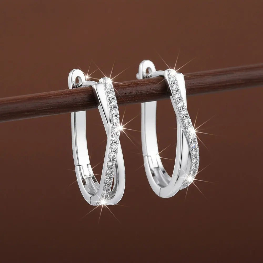 Bee-Bees sterling silver twisted hoop earrings with D Color VVS1 moissanite stones, 18K white gold plated.