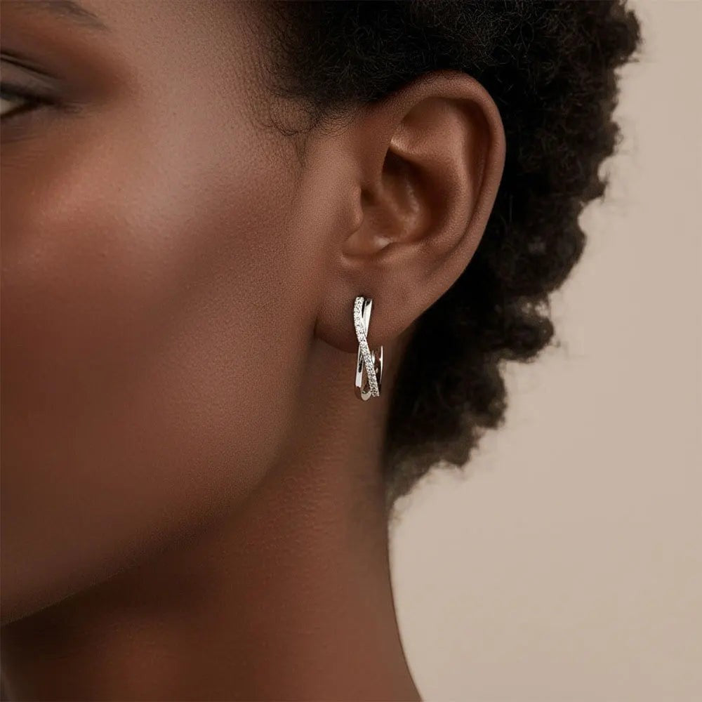 Bee-Bees sterling silver twisted hoop earrings with D Color VVS1 moissanite stones.