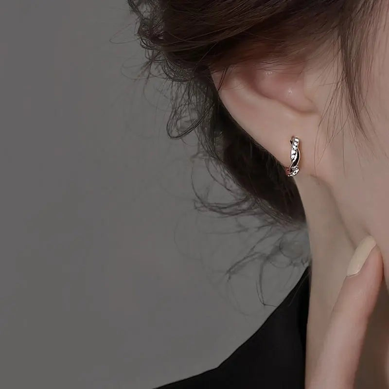 Bee-Bees small white gold moissanite hoop earrings with twisted detail and sparkling stones.
